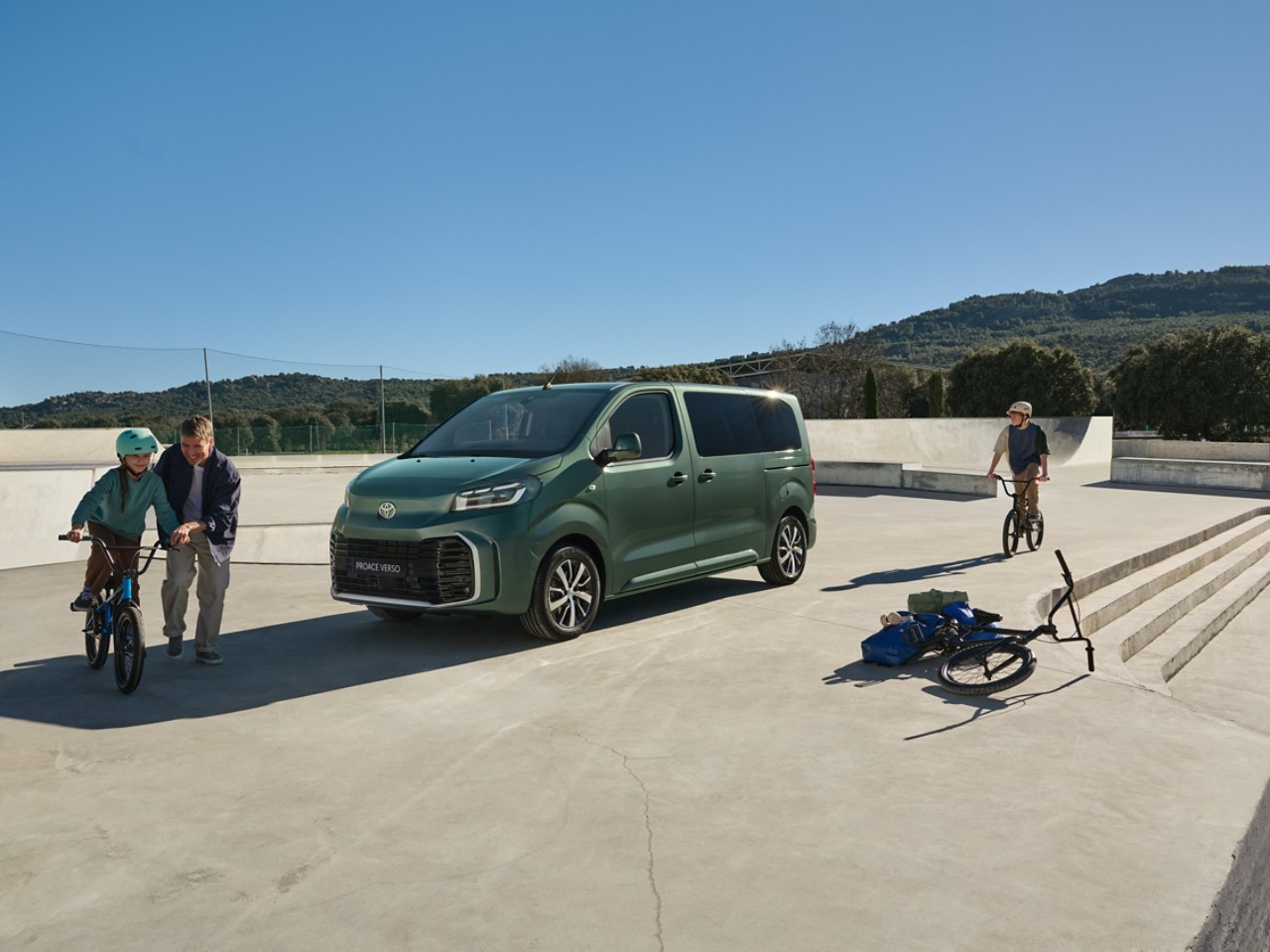 A Toyota Proace drives a long country road